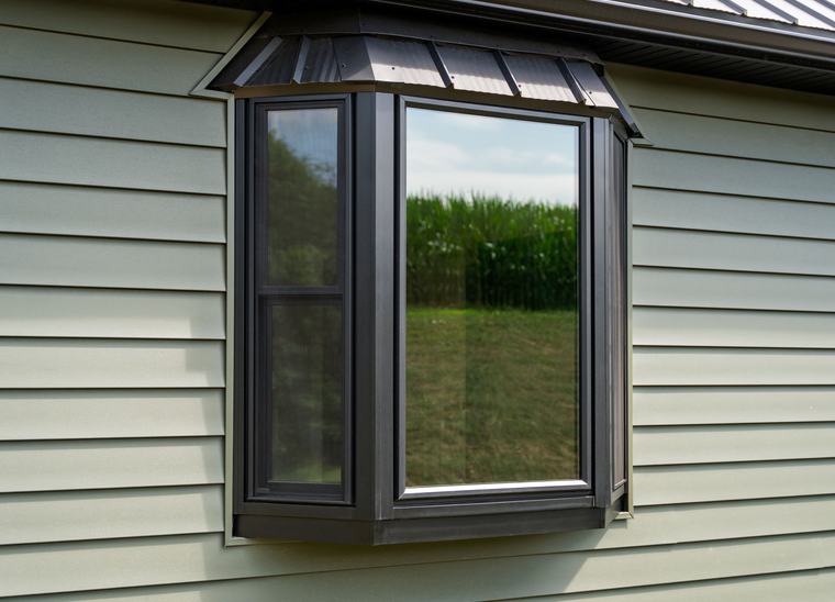 A ProVia bay window with a coal black exterior and metal roof