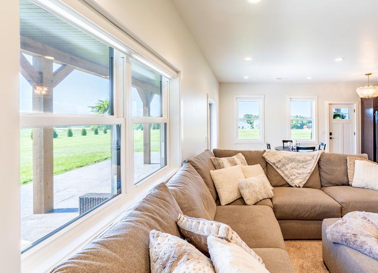 A wide ProVia picture window filling a living room with daylight